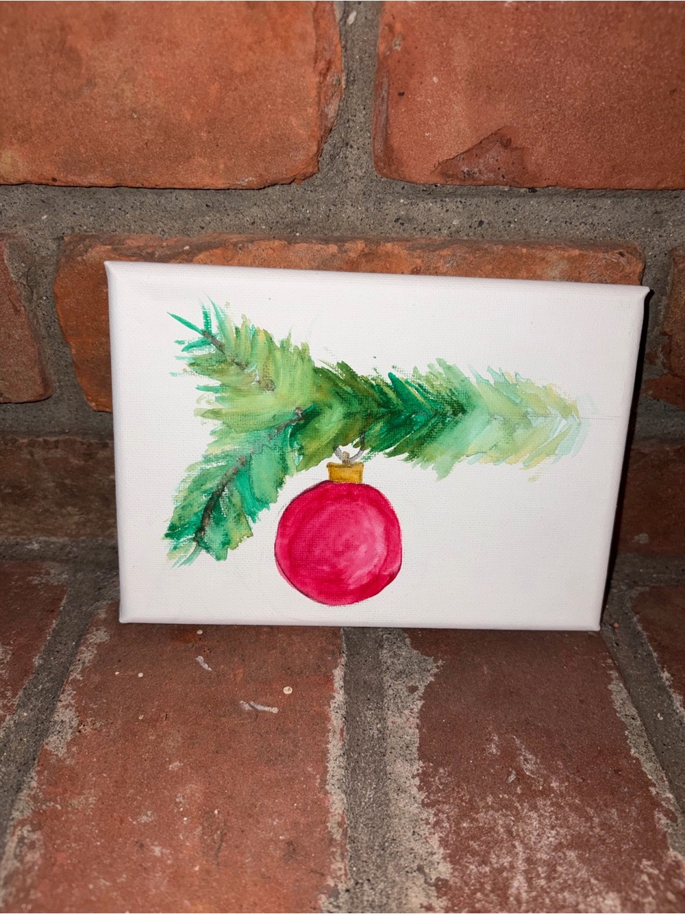 Hand-Painted Holiday Canvas Art with Green Pine Branch and Red Ornament